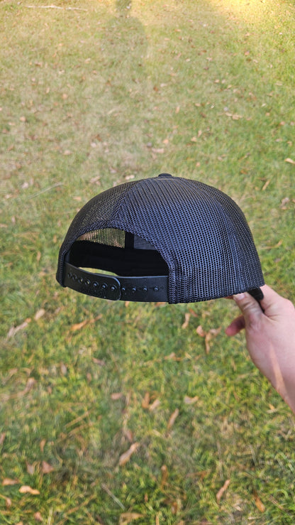 Rear detail of a black Richardson hat showing the mesh back and adjustable snapback closure